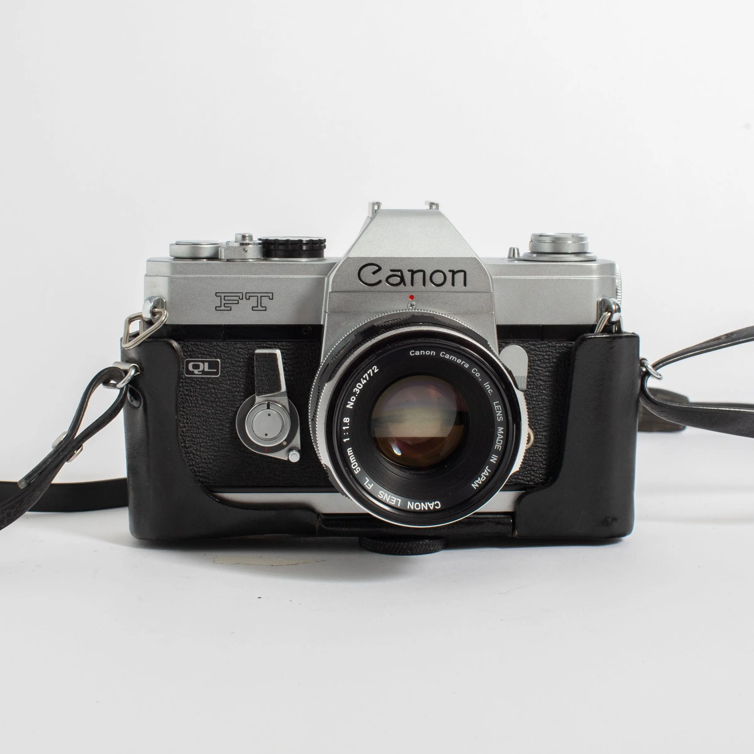 Canon FT QL w/ FL 50mm f/1.8 lens, leather casing, and strap